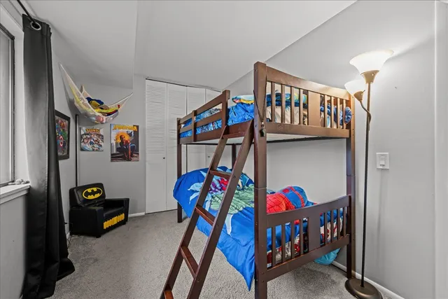 a living room with lots of furniture and baby crib