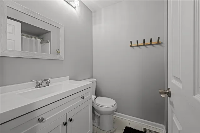a bathroom with a sink mirror and toilet