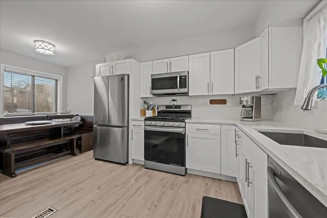 a kitchen with a refrigerator stove and sink