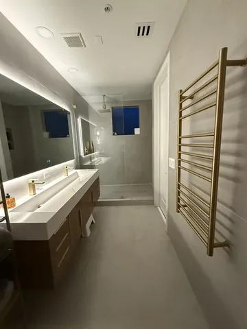 a bathroom with a sink a mirror and a bathtub