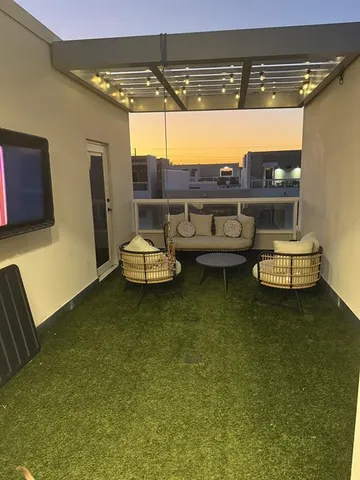 a living room with furniture and a floor to ceiling window