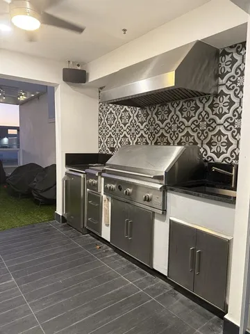 a kitchen with a stove and a refrigerator