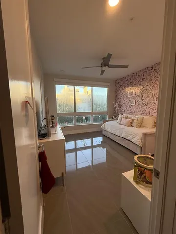 a living room with furniture and a floor to ceiling window