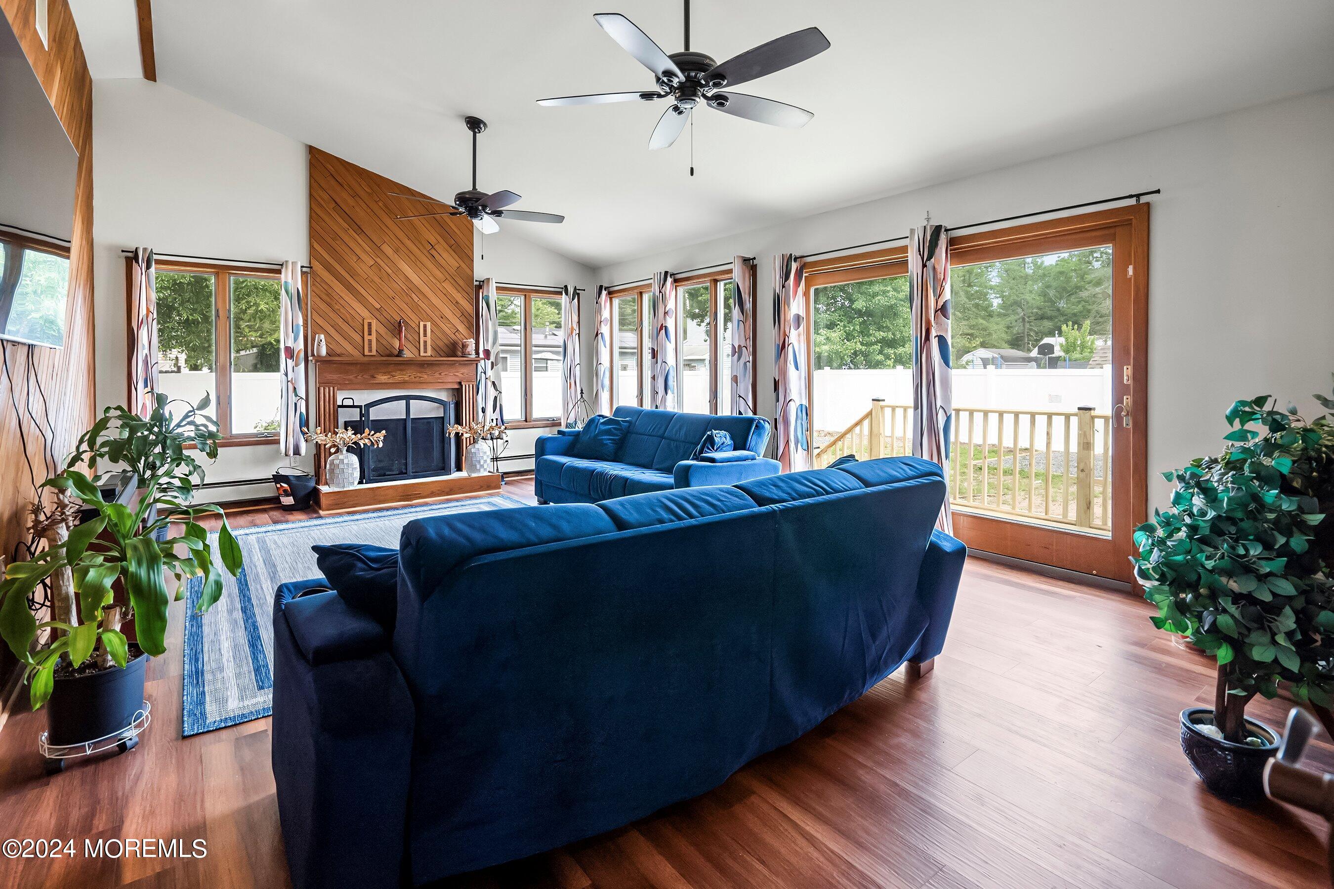 34 Maple Street Waretown, NJ 08758 - Photo 21 of 36 a living room with furniture potted plant floor to ceiling windows and a potted plant
