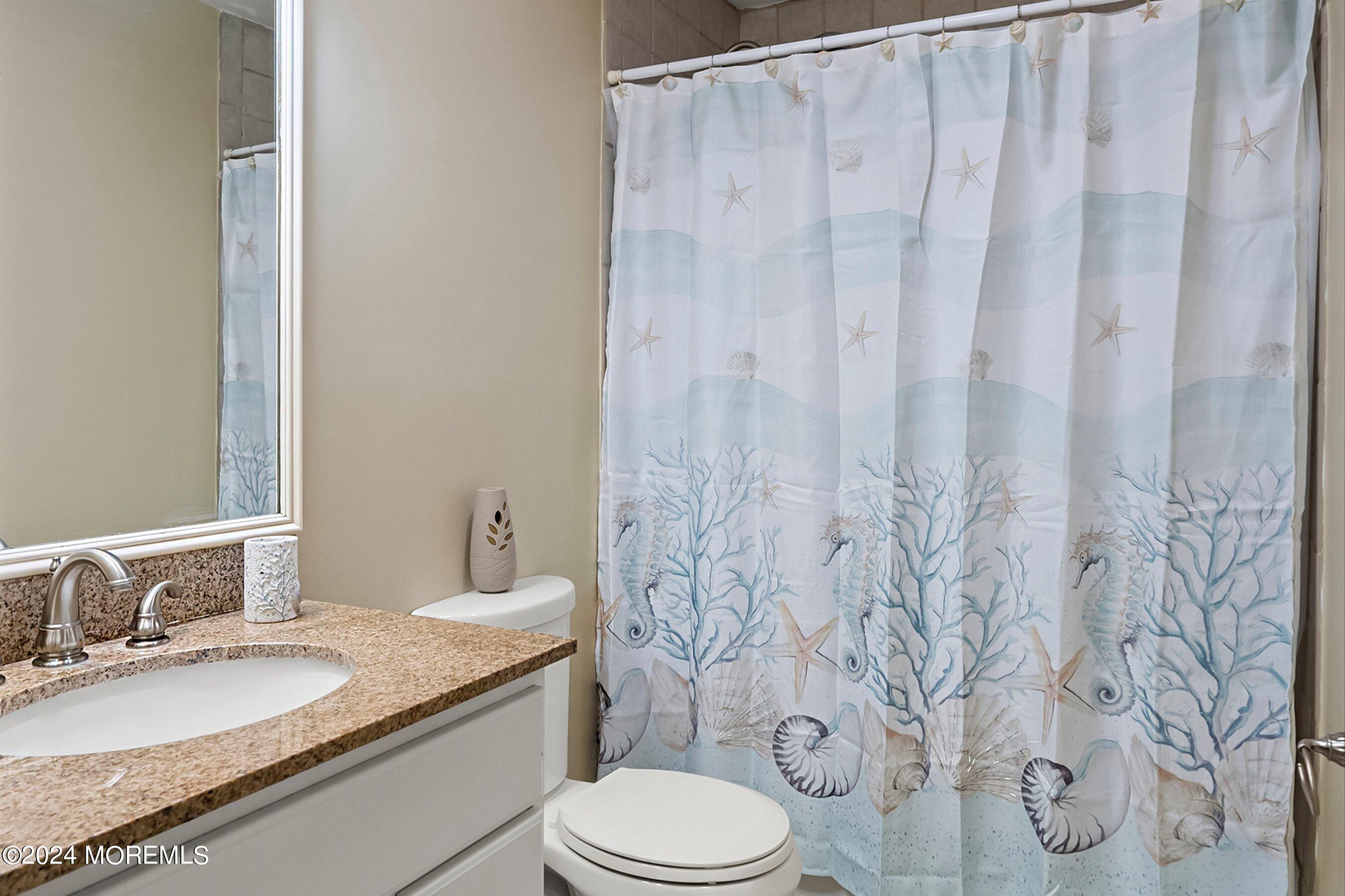 34 Maple Street Waretown, NJ 08758 - Photo 32 of 36 a bathroom with a granite countertop sink and a mirror