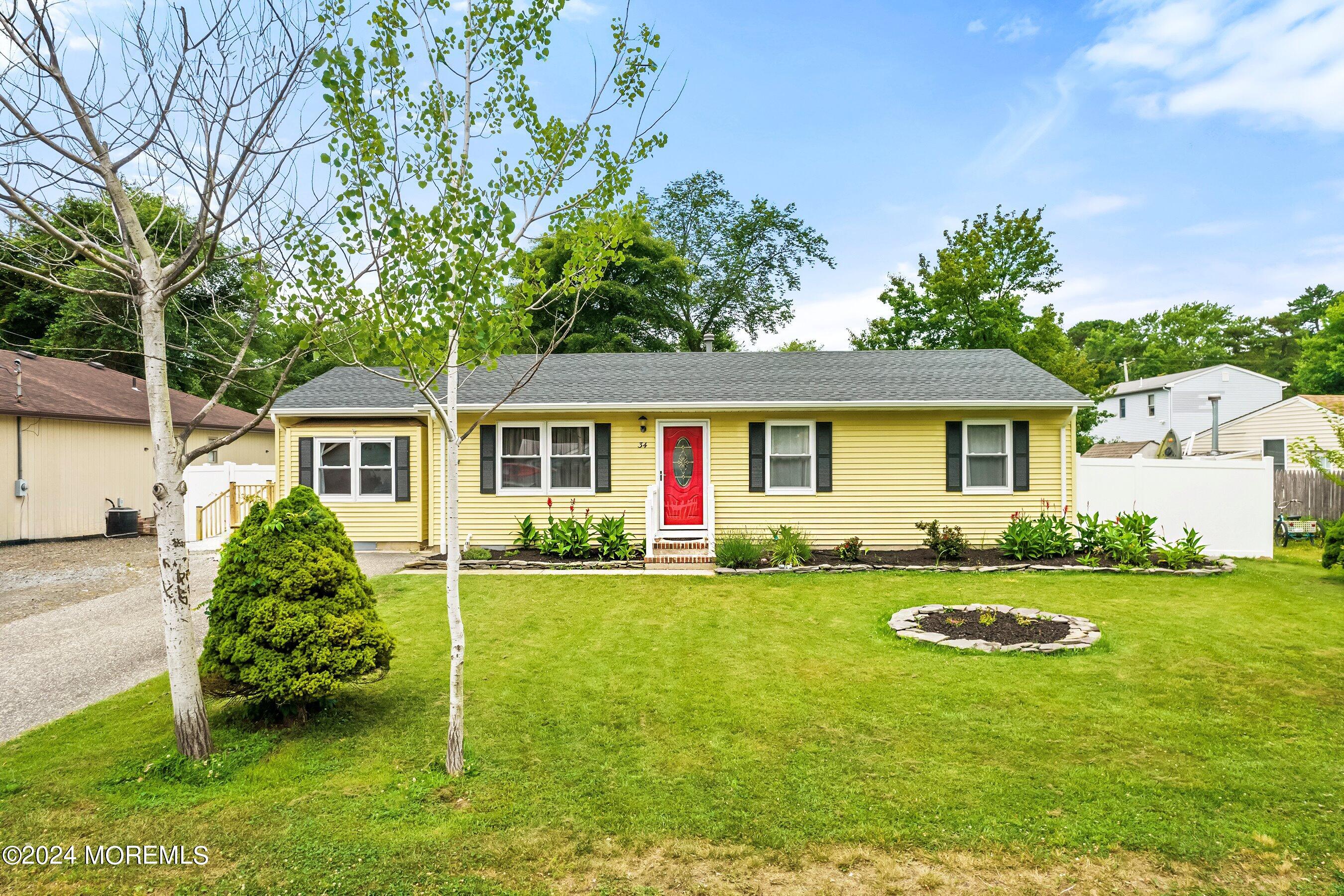 34 Maple Street Waretown, NJ 08758 - Photo 8 of 36 a front view of a house with garden