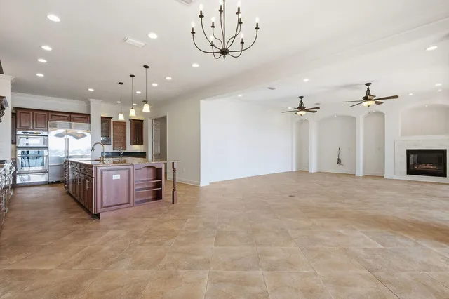 a kitchen with granite countertop a refrigerator and a sink