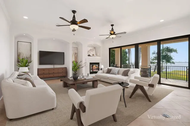 an empty room with windows and fireplace