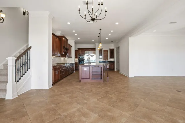 a bathroom with a granite countertop sink and a large mirror