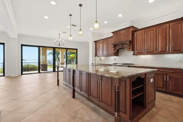 a spacious bathroom with a granite countertop sink a toilet and a vanity