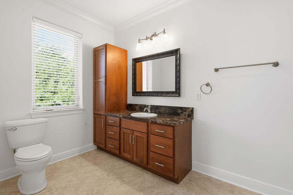 18 Kimbrough Road Mary Esther, FL 32569 - Photo 45 of 89 a bathroom with a toilet sink and mirror