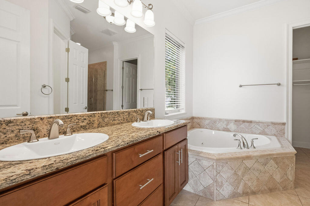 18 Kimbrough Road Mary Esther, FL 32569 - Photo 55 of 89 a bathroom with a granite countertop bathtub sink and mirror