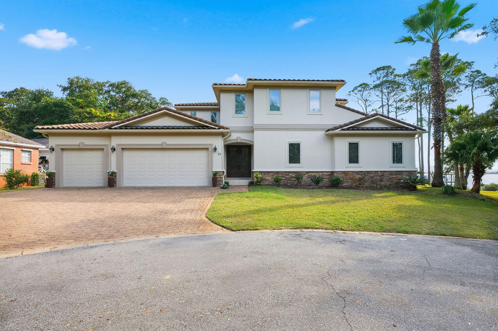 18 Kimbrough Road Mary Esther, FL 32569 - Photo 85 of 89 a front view of a house with a yard and garage
