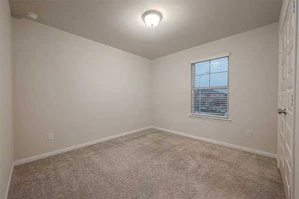 an empty room with closet area