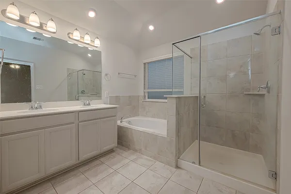 a white bath tub sitting next to a bathroom sink