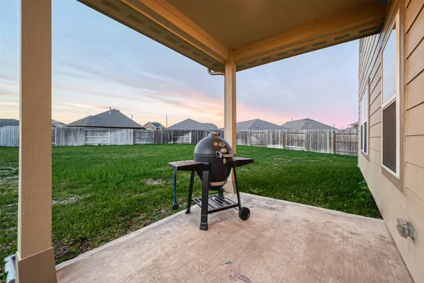 a view of a house with a yard and sitting area