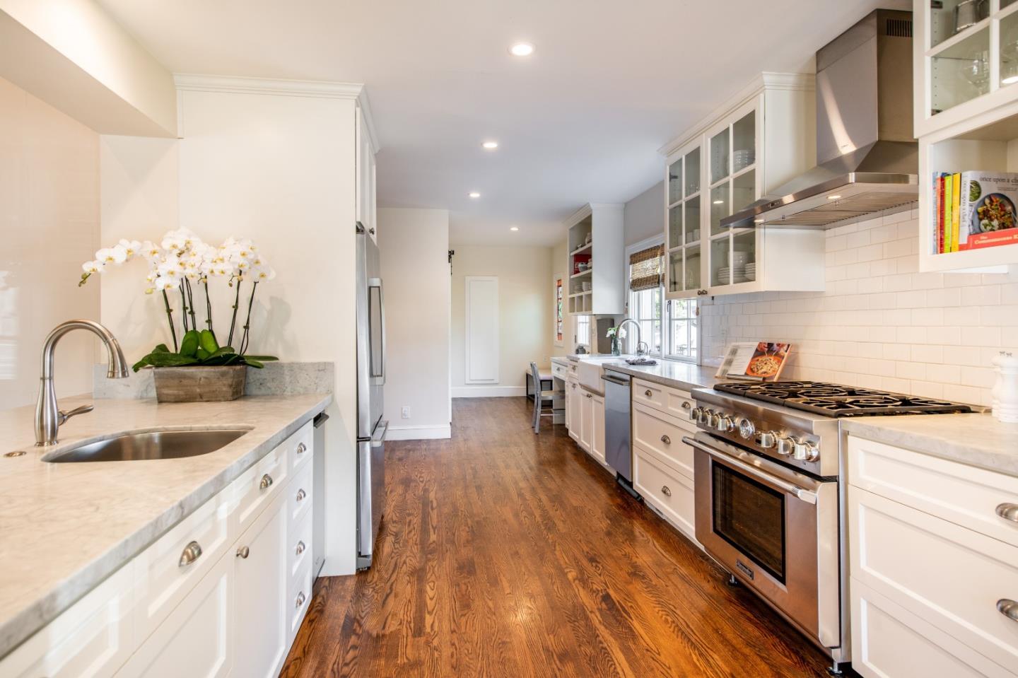 843 Crossway Road Burlingame, CA 94010 - Photo 11 of 36 a kitchen with stainless steel appliances granite countertop a stove and a sink