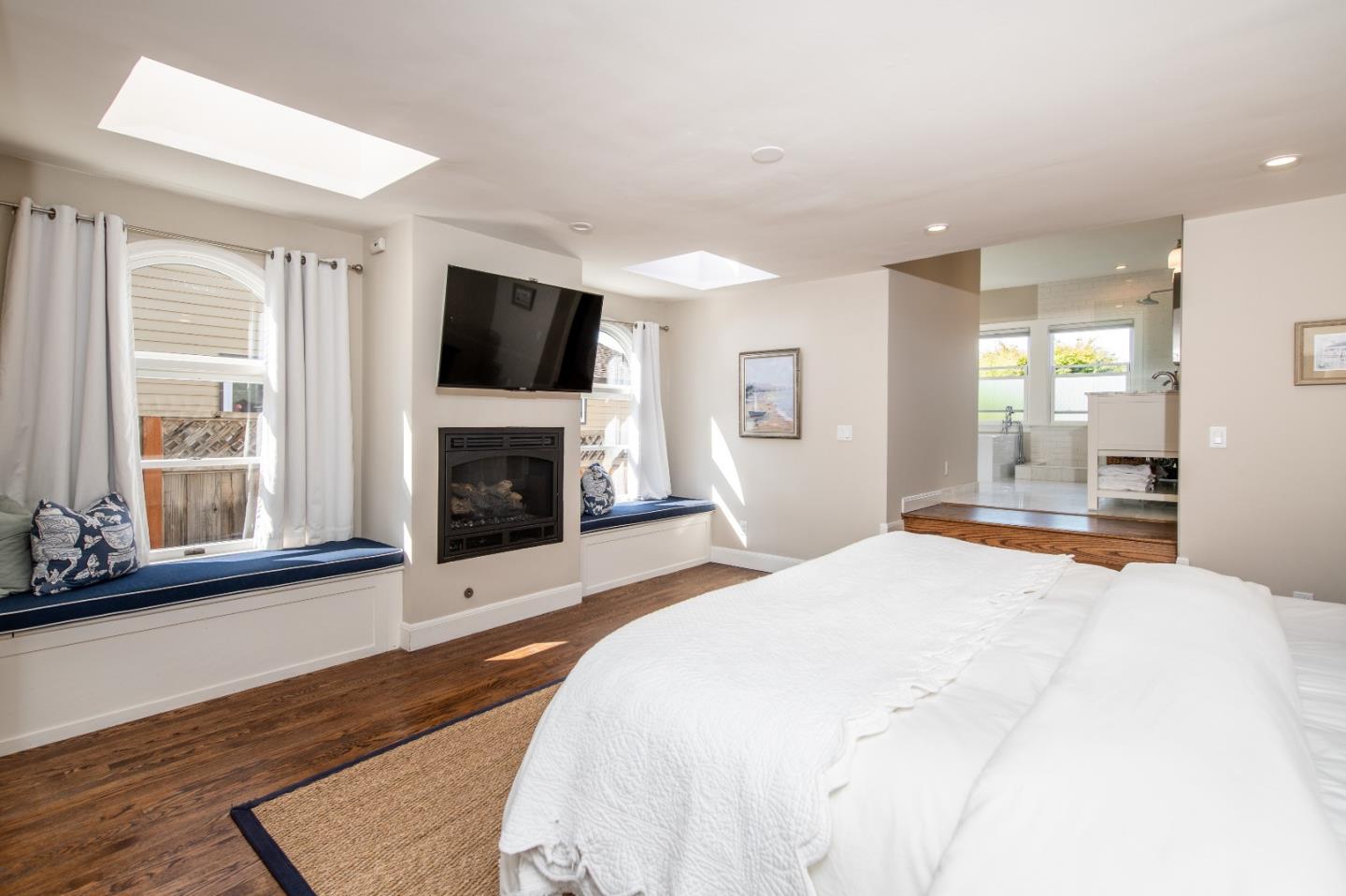 843 Crossway Road Burlingame, CA 94010 - Photo 16 of 36 a spacious bedroom with a bed and a flat screen tv