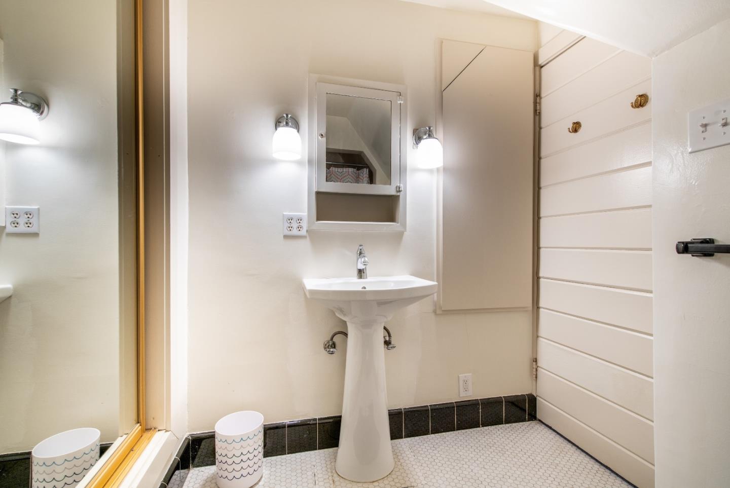 843 Crossway Road Burlingame, CA 94010 - Photo 20 of 36 a bathroom with a sink and a mirror