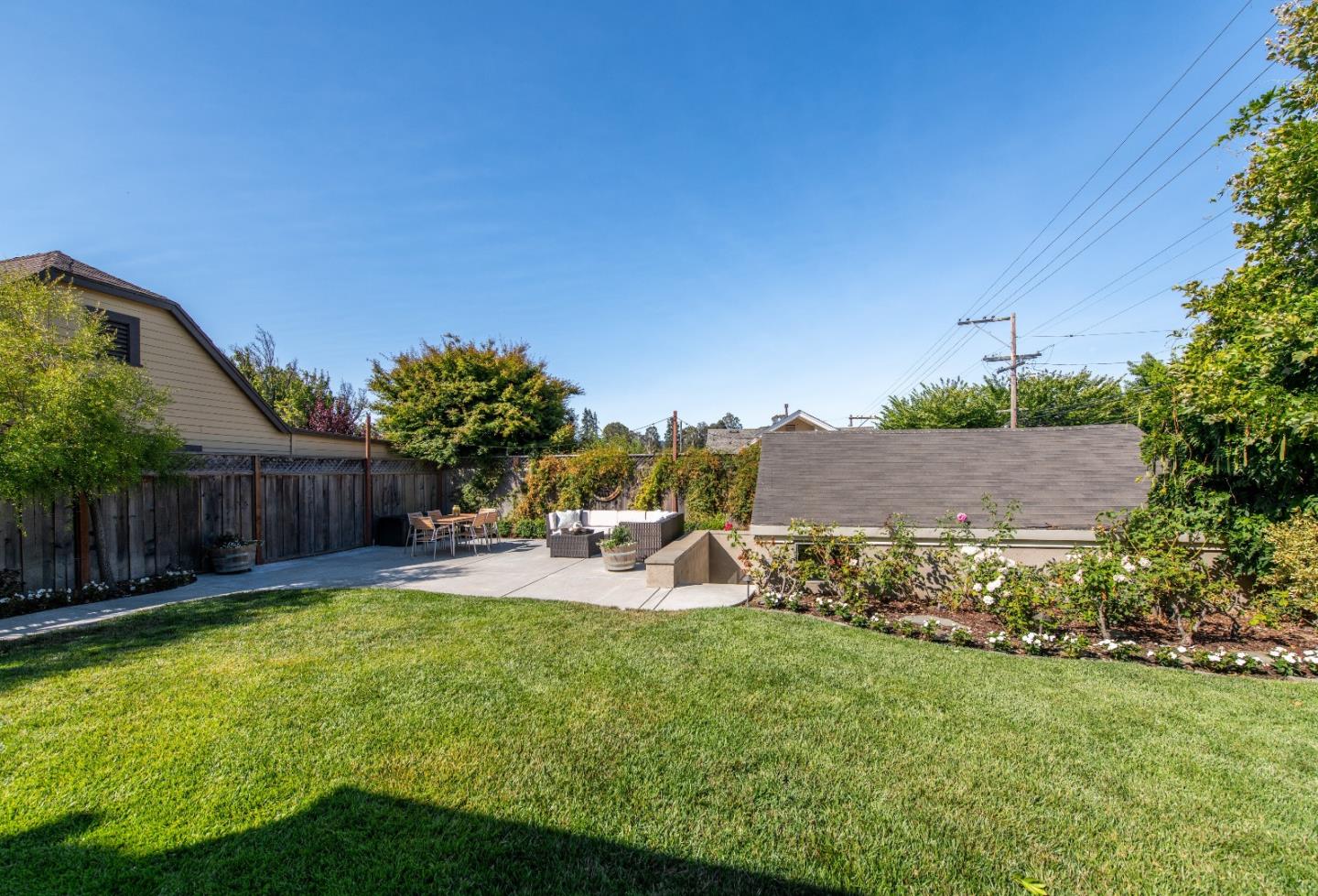 843 Crossway Road Burlingame, CA 94010 - Photo 34 of 36 a view of a backyard with table and chairs potted plants and wooden fence