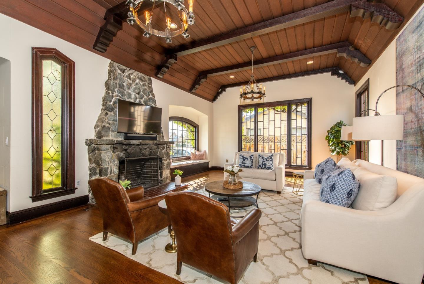 843 Crossway Road Burlingame, CA 94010 - Photo 4 of 36 a living room with furniture a fireplace and a flat screen tv
