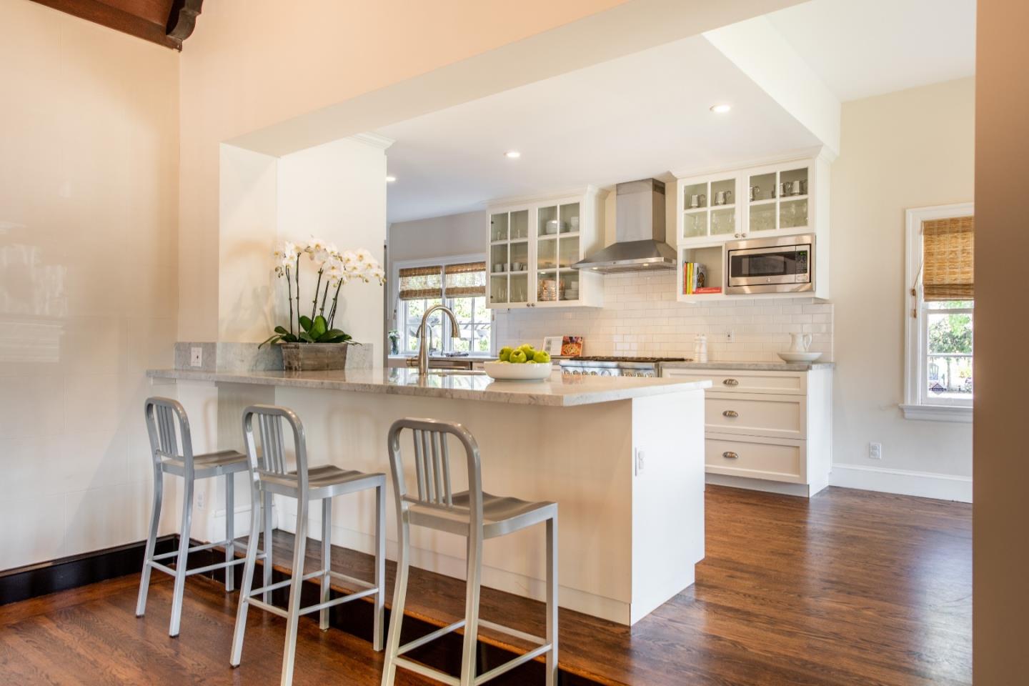 843 Crossway Road Burlingame, CA 94010 - Photo 9 of 36 a open kitchen with stainless steel appliances granite countertop a table and chairs in it