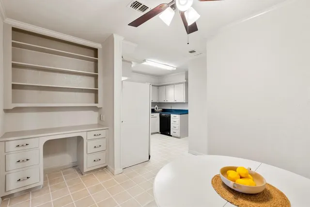 a kitchen with granite countertop white cabinets and white appliances