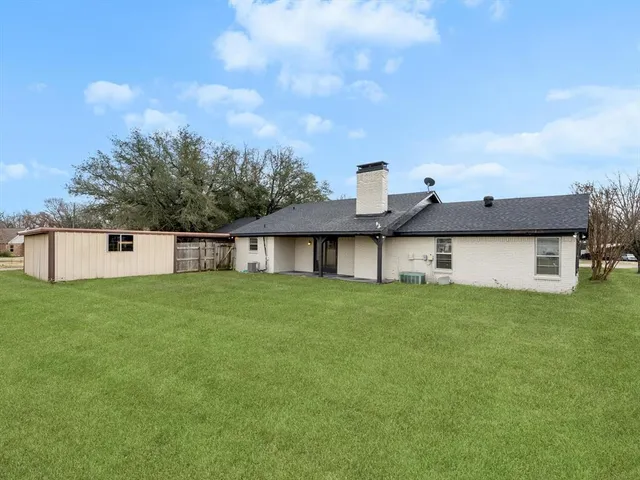 an aerial view of a house with outdoor space