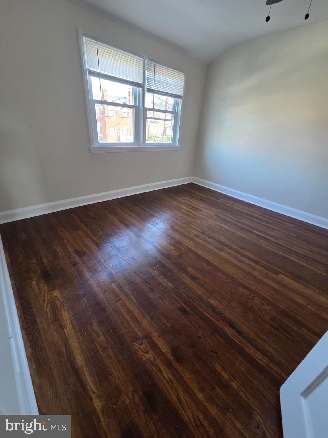 1930 Frames Road Dundalk, MD 21222 - Photo 25 of 30 a view of an empty room with wooden floor and a window