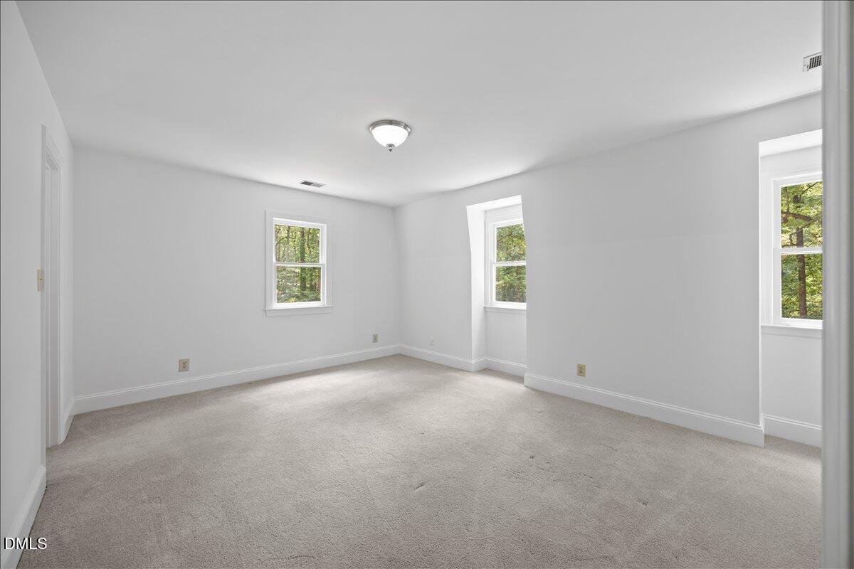 6516 Bakersfield Drive Raleigh, NC 27606 - Photo 40 of 59 an empty room with windows