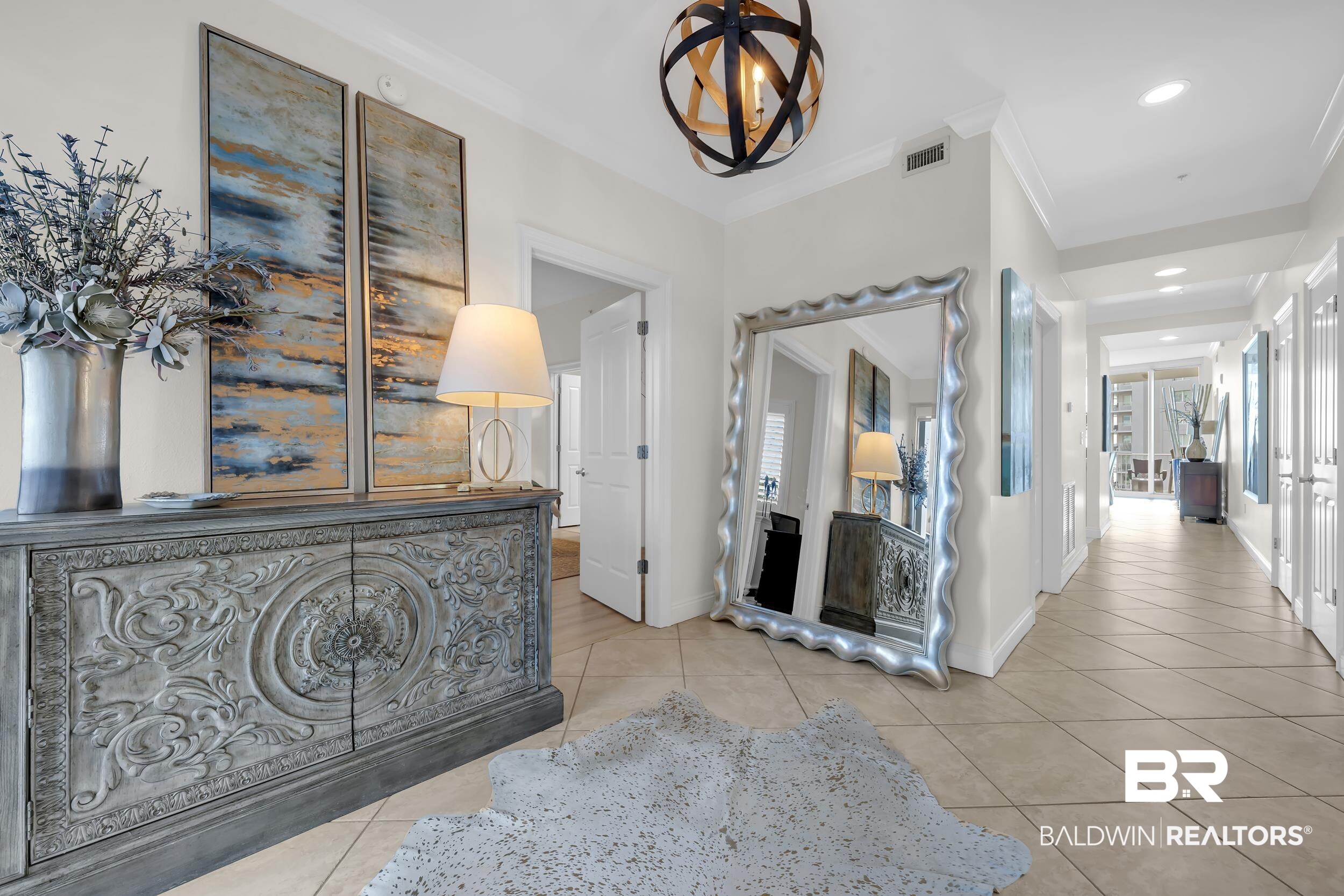 28250 Canal Road, Unit 307 Orange Beach, AL 36561 - Photo 17 of 56 Hall with hanging lights, light tile patterned floors, and ornamental molding