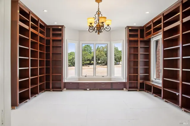 a view of an empty room and a window