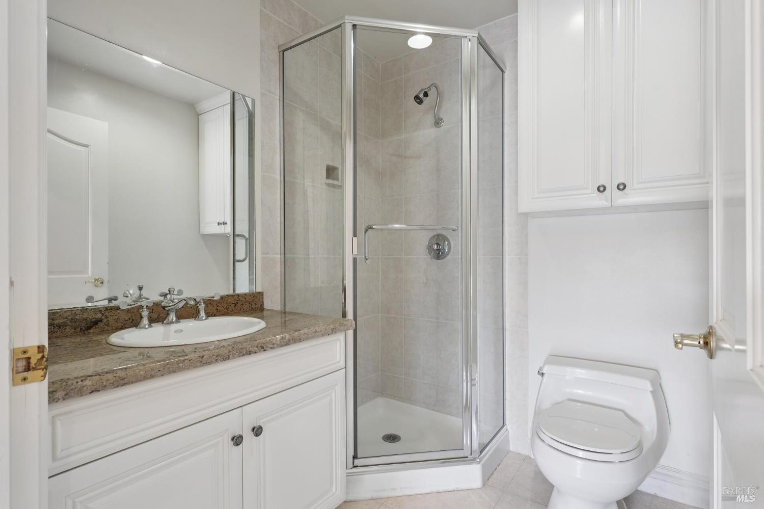 5151 Wild Horse Valley Road Napa, CA 94558 - Photo 44 of 81 a bathroom with a granite countertop sink toilet and shower