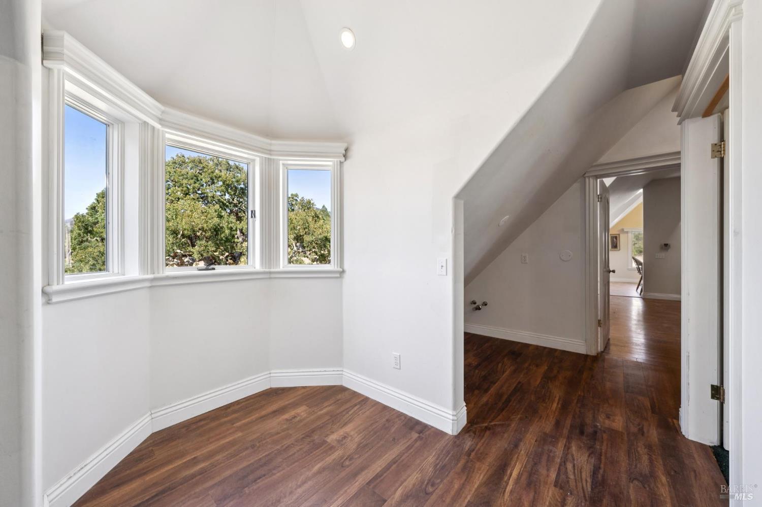 5151 Wild Horse Valley Road Napa, CA 94558 - Photo 63 of 81 a view of an empty room with wooden floor and a window