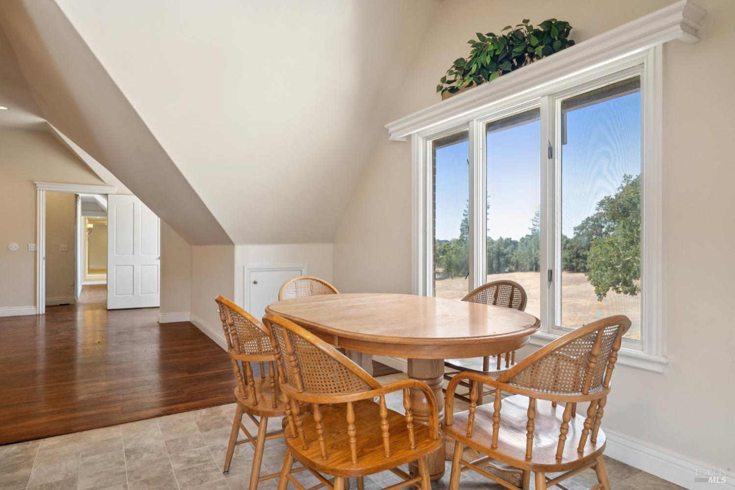 5151 Wild Horse Valley Road Napa, CA 94558 - Photo 64 of 81 a dining room with furniture window and wooden floor
