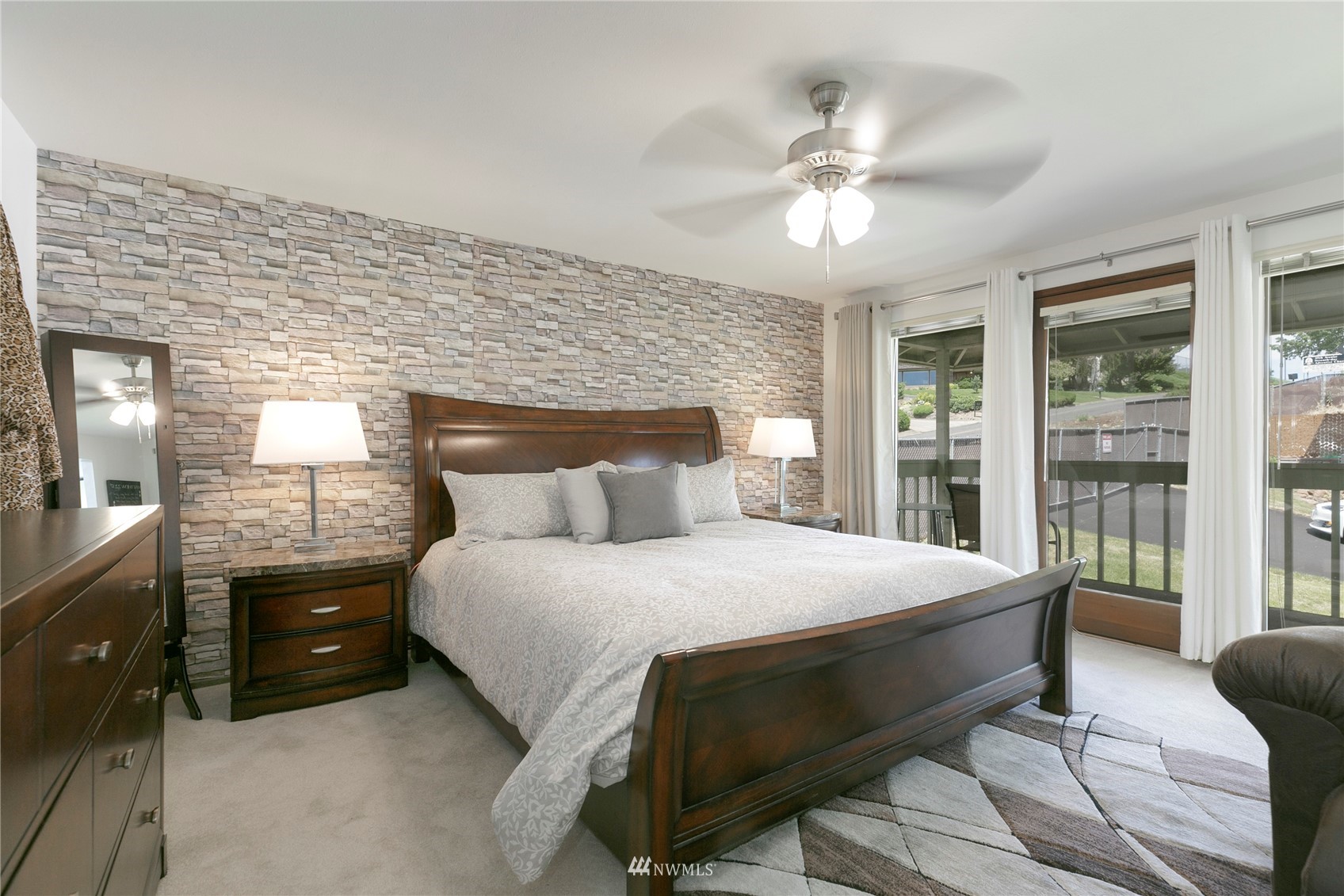 24 Burning Tree Drive Yakima, WA 98902 - Photo 13 of 18 a bedroom with a bed and a chandelier