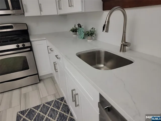 a kitchen with a sink and cabinets