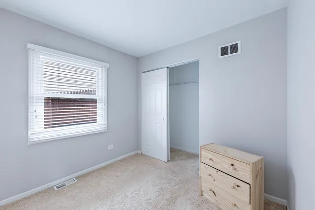 a view of room with closet and windows