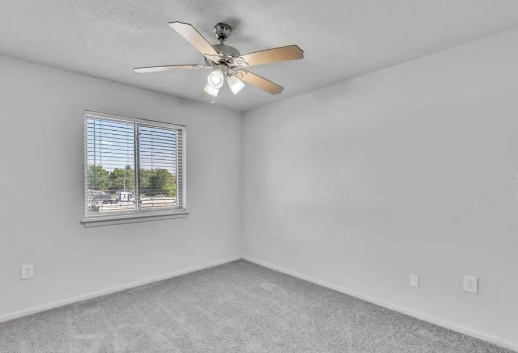 1401 Longcreek Drive Columbia, SC 29210 - Photo 8 of 9 an empty room with a window and a fan