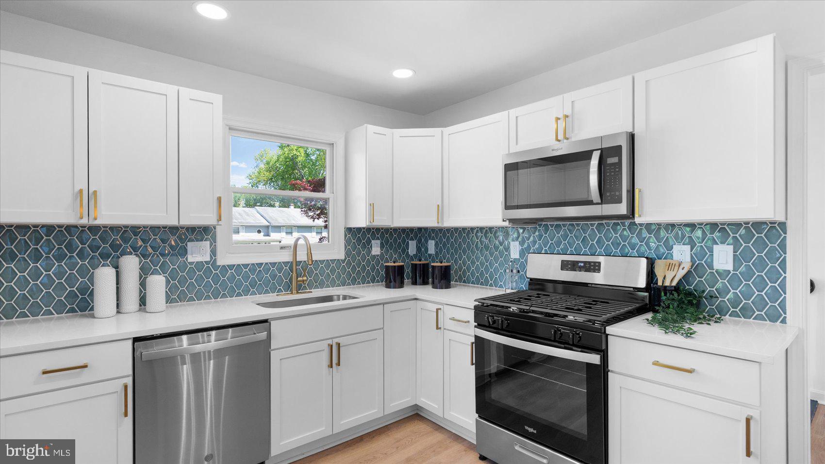 804 Suburbian Road Reisterstown, MD 21136 - Photo 12 of 36 a kitchen with stainless steel appliances granite countertop white cabinets granite counter tops and a window