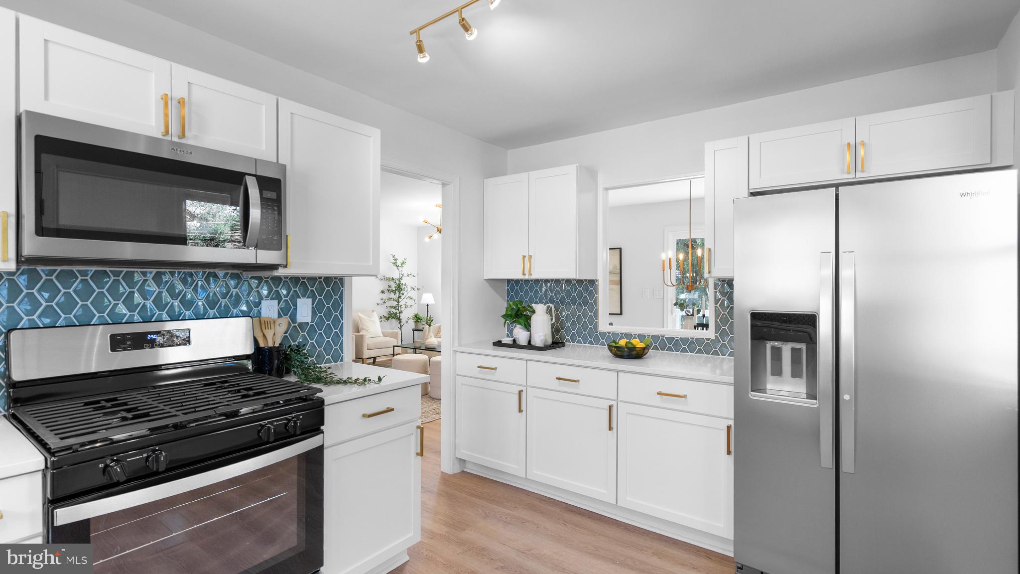 804 Suburbian Road Reisterstown, MD 21136 - Photo 14 of 36 a kitchen with white cabinets and stainless steel appliances