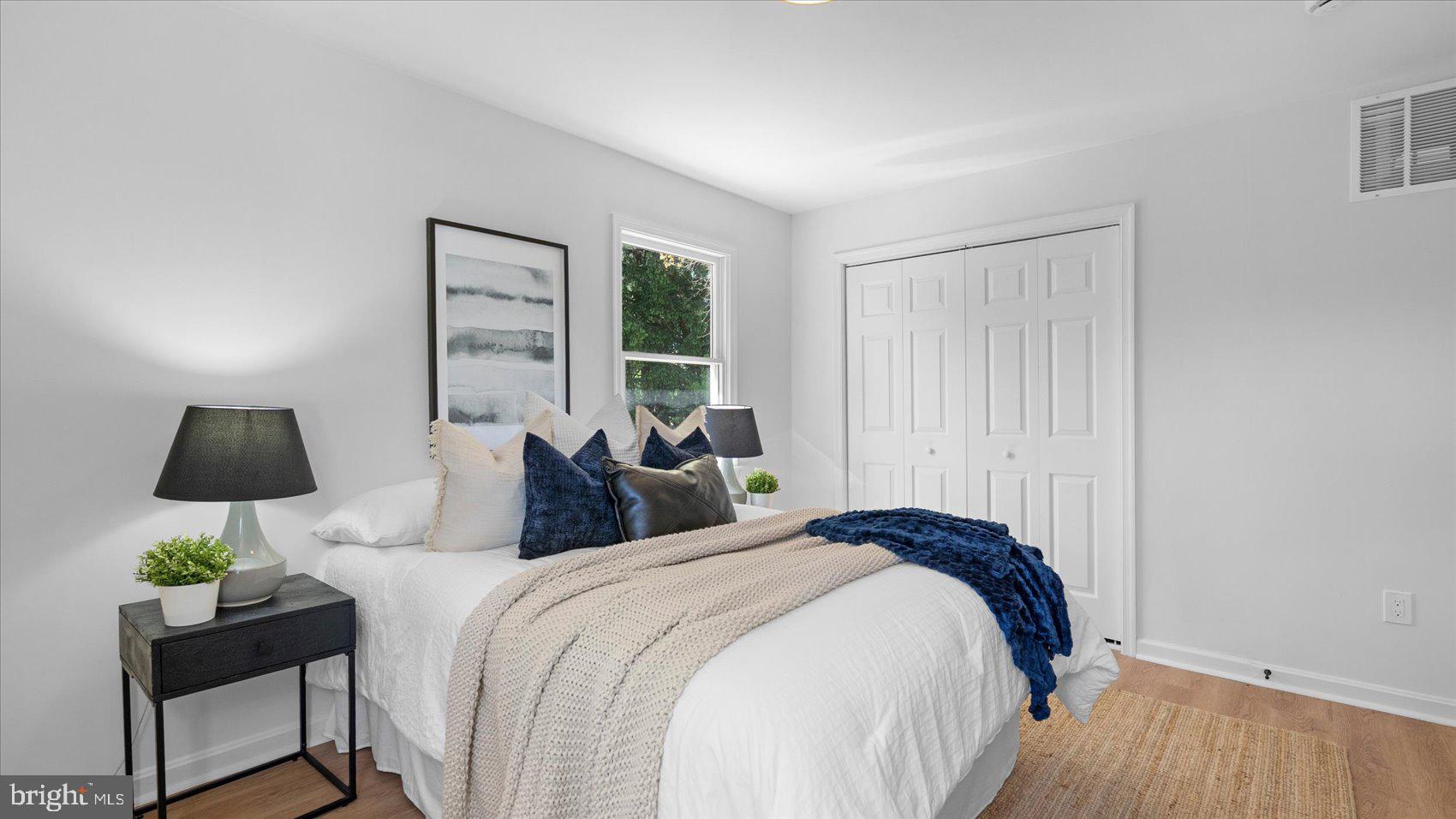 804 Suburbian Road Reisterstown, MD 21136 - Photo 19 of 36 a bedroom with bed a lamp and a potted plant