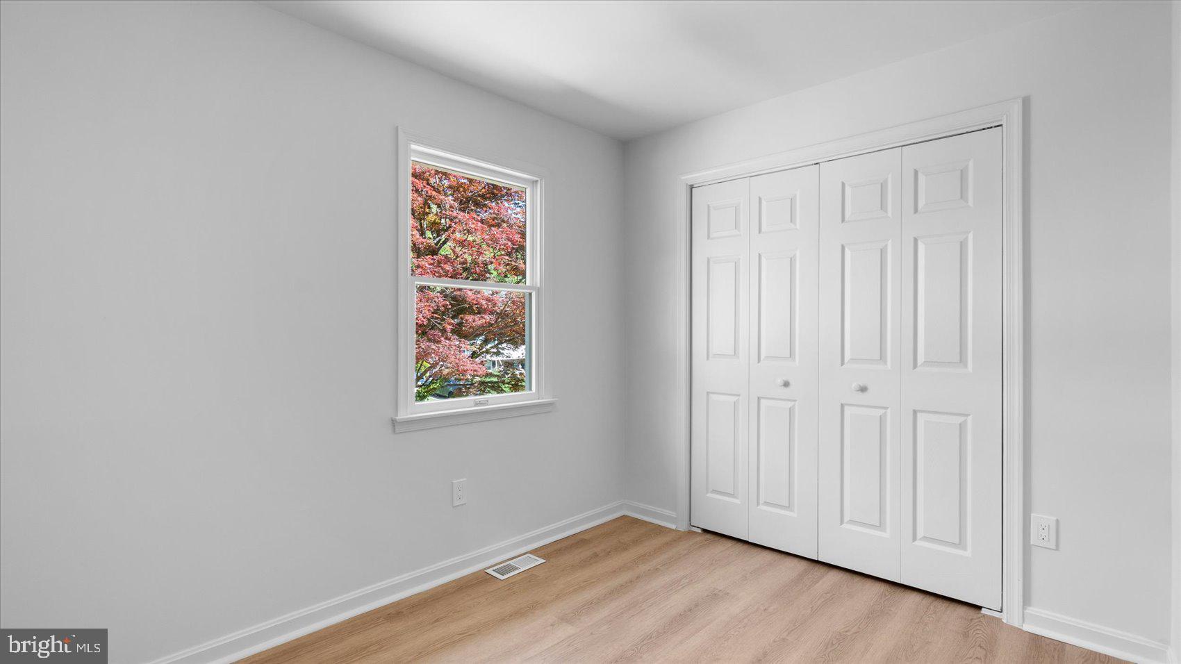 804 Suburbian Road Reisterstown, MD 21136 - Photo 21 of 36 an empty room with wooden floor and windows