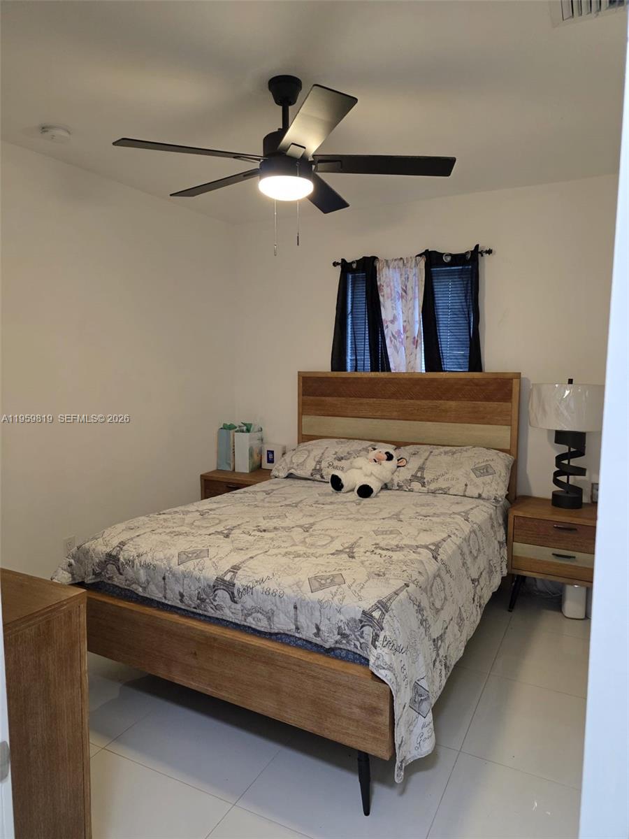 8523 Northwest 35th Place Miami, FL 33147 - Photo 6 of 10 a bed sitting in a bedroom chandelier