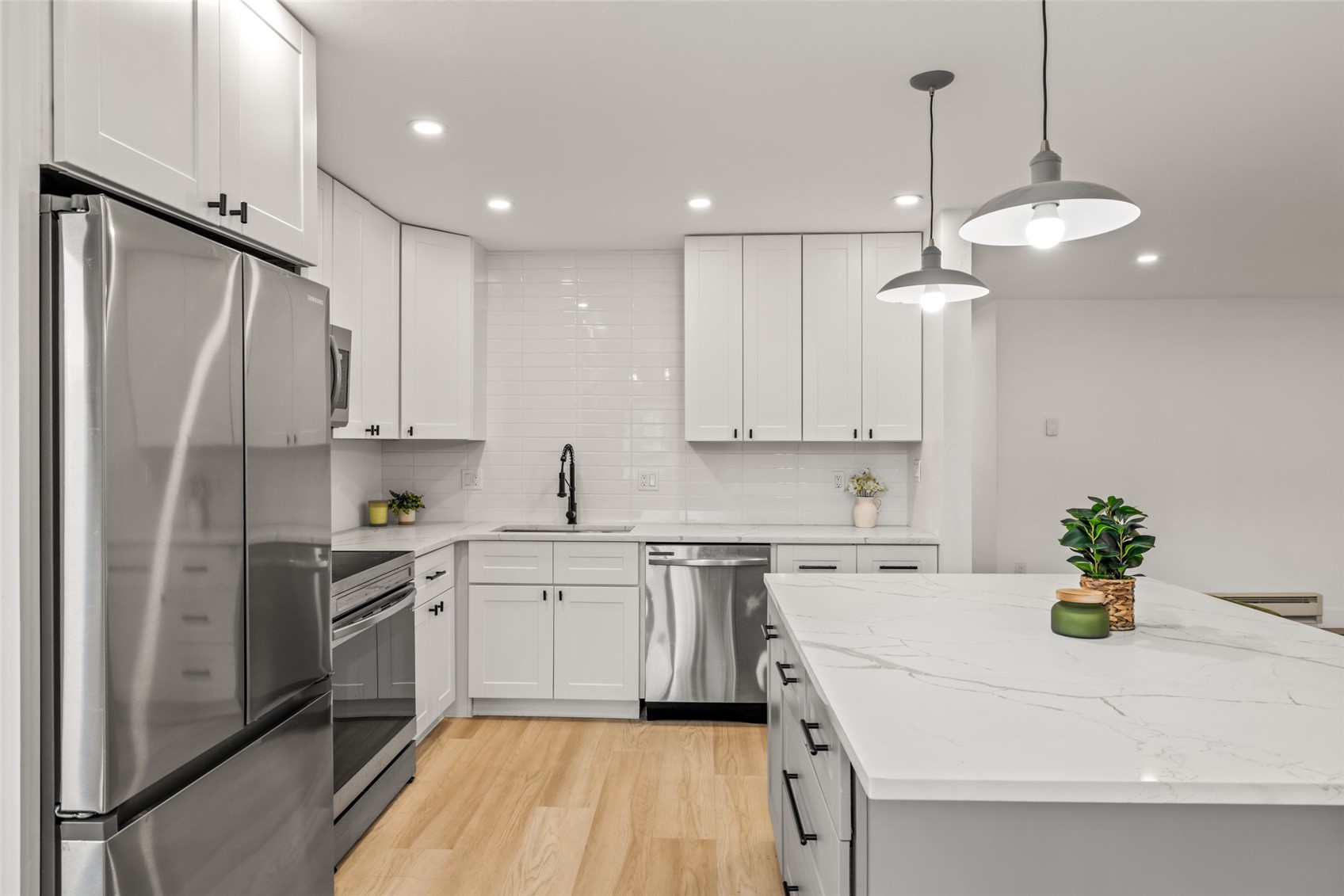 1375 Walton Creek Road, Unit 7 Steamboat Springs, CO 80487 - Photo 6 of 21 a kitchen with stainless steel appliances granite countertop a sink a stove a refrigerator and island with wooden floor