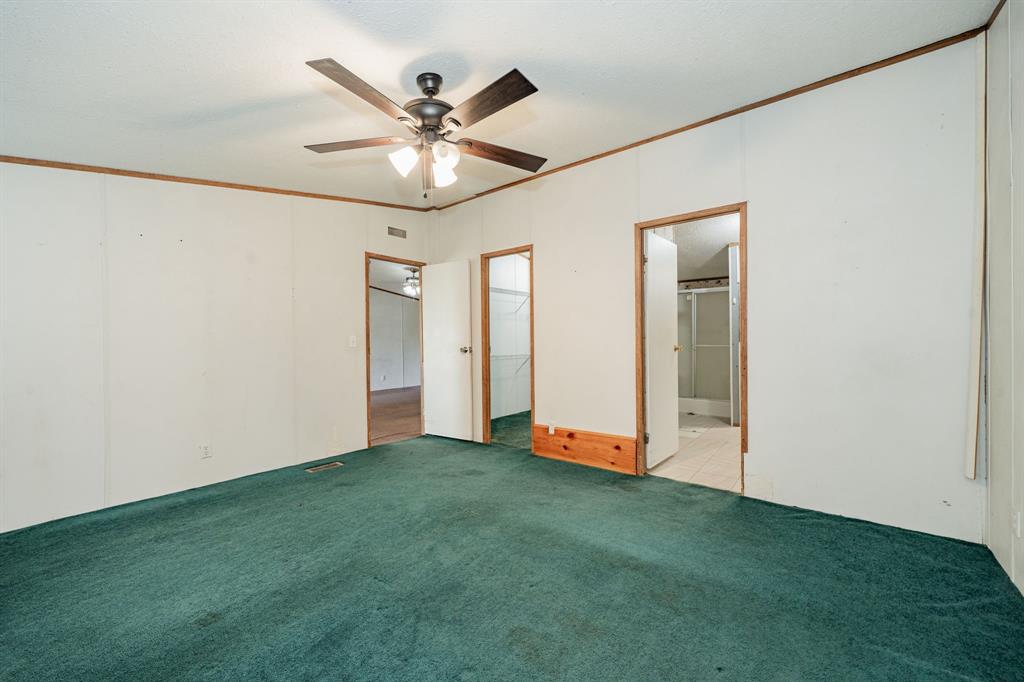 1312 Crowell Road Kaufman, TX 75142 - Photo 13 of 38 an empty room with closet and a chandelier fan