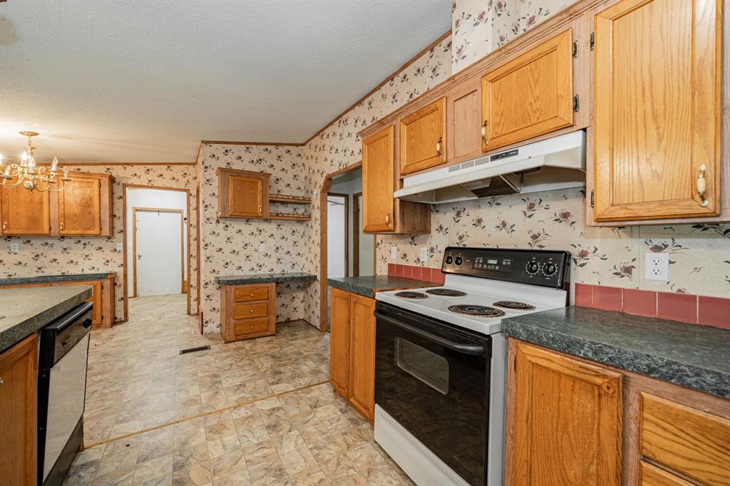 1312 Crowell Road Kaufman, TX 75142 - Photo 18 of 38 a kitchen with stainless steel appliances granite countertop a stove top oven a sink and dishwasher