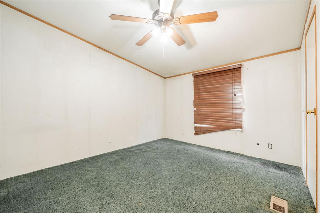 1312 Crowell Road Kaufman, TX 75142 - Photo 26 of 38 an empty room with windows and fan