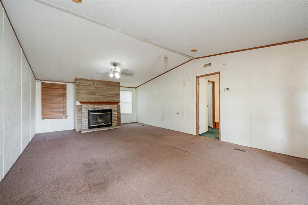 1312 Crowell Road Kaufman, TX 75142 - Photo 9 of 38 a view of an empty room with a fireplace