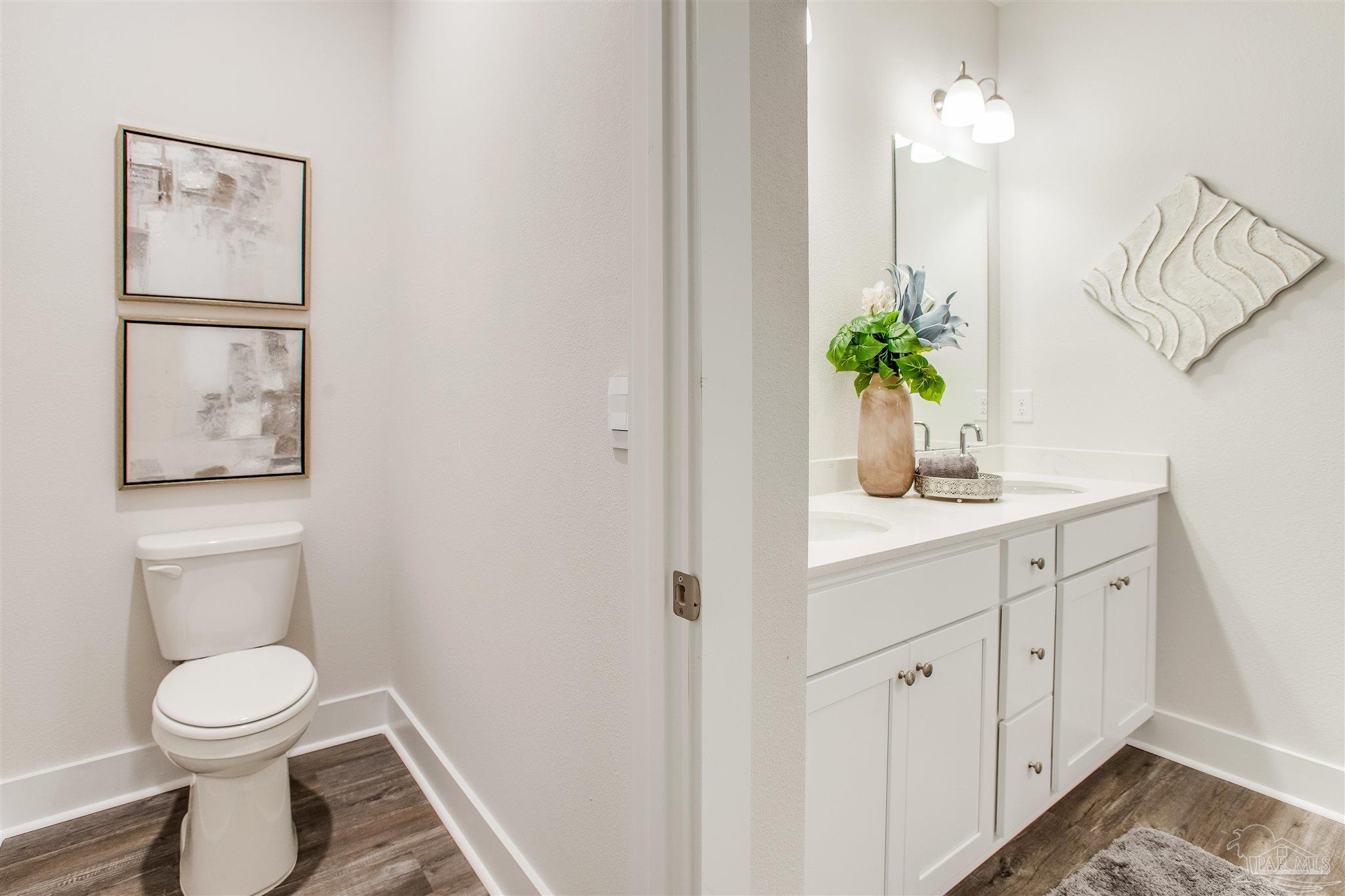 3452 Serviceberry Road Cantonment, FL 32533 - Photo 16 of 38 a bathroom with a toilet a sink and vanity